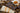 Chugach chocolate bar with Alaska birch syrup toffee bits on a wooden surface